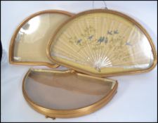 A Victorian mother of pearl and silk embroidery fan depicting song birds perched on a tree inside an