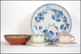 A late 18th century early 19th English Delft plate, blue and white floral patterned together with