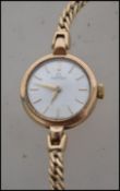 A vintage ladies 9ct gold / 375 marked Omega dress watch set to an Omega linked chain with safety