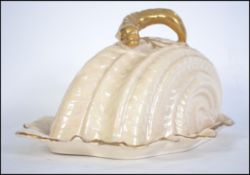 A good 19th century Staffordshire Cheese dish of rococo form having scalloped gilded decoration