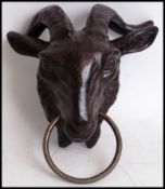 A vintage style, 20th century cast iron goats head with ring through its nose. Measures 19cms wide.