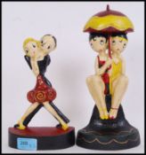 Two vintage style, 20th century cast iron art deco doorstops of dancers. Tallest measures 26cms.