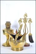 A collection of early 20th century brass wares comprising of a complete companion fireside set, a