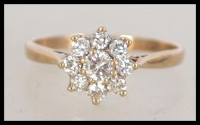 A 9ct gold diamond cluster daisy ring, the diamond