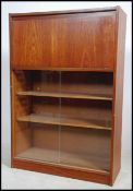 A retro 1970's Danish influence teak wood china display cabinet having sliding glass bookcase /