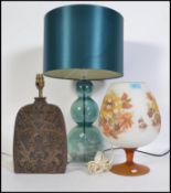 A Tiki ( Polynesian style ) lamp base along with retro lamp in the form of an over sized brandy