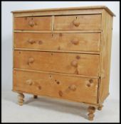 A Victorian country pine 2 over 3 chest chest of drawers being raised on turned legs having a 2