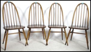 An Ercol golden dawn beech and elm constructed Beamish dining table together with a set of four