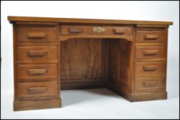 A 1920's Industrial oak twin pedestal office desk
