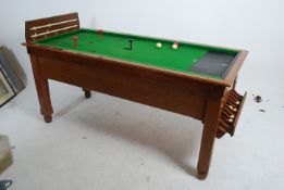 An early 20th century golden oak bar billiards tab