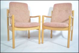 A pair of 20th century Ercol staff chairs. Light b