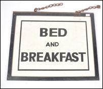 A retro mid century wooden double sided advertisin