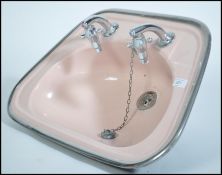 A 1950's two tone pink and black metal bathroom si