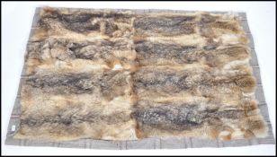 A mid 20th century retro wolf skin rug of rectangu
