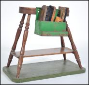 A mid century shoe shine boys stool stand having w