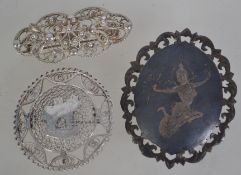 A group of three silver white metal broo