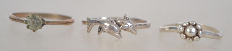 A group of three rings two being silver