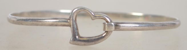A silver 925 bangle with heart design wi