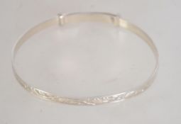 A silver rococo chased expanding bracele