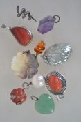 A collection of silver necklace pendants