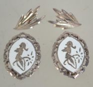 Two pairs of silver earrings one being a