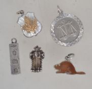 A collection of 5 silver charms to inclu