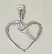 A 9ct white gold necklace pendant in the form of a heart with illusion set diamond being marked 375