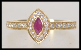 A ladies 18ct gold ruby and diamond cluster ring. The diamonds approx 60pnts total.