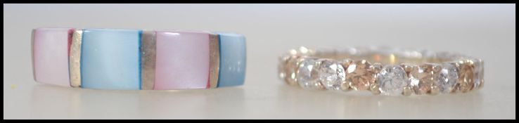 Two contemporary silver ladies dress rings to include a cz round cut adorned full eternity ring and