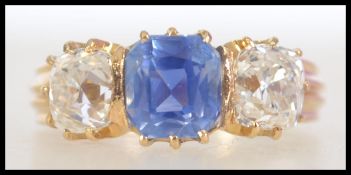 A 18ct gold sapphire and diamond 3 stone ring with central cushion cut sapphire flanked by two old
