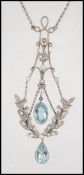 An Edwardian 18ct gold Art Nouveau pendant necklace strung with stylized rose cut diamond set