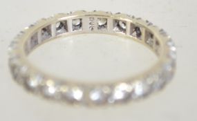 A 9ct gold eternity ring set with clear stones. Weight 2.4g. Size L. Marked 9ct tests 9ct gold.