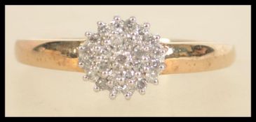A 9ct gold diamond cluster ring. Hallmarked for London. Weight 2.8g. Size U. Diamonds approx 25pts.