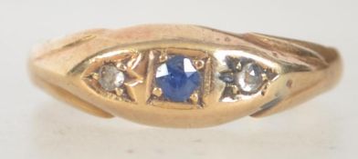 A Victorian hallmarked 22ct gold sapphire and diamond ring in a gypsy mount set with a central