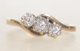 A hallmarked 9ct gold and diamond ladies 3 stone crossover ring . Hallmarked for Sheffield.