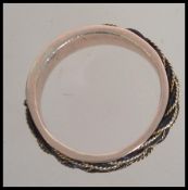 A 15ct gold Victorian band ring set with a filigree and elephant hair plat. Size.T.5.