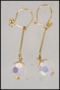 A pair of contemporary 9ct yellow gold ladies drop earrings with faced glass sphere stones.