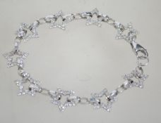 A hallmarked 9ct white gold star linked ladies bracelet inset with cz stones with a lobster claw