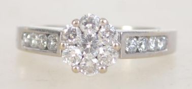 A 14ct white gold and diamond ring, the large central flower head stones approx 1ct. Size P.