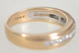 A hallmarked 9ct gold and diamond channel set ring. The diamonds approx 25pnts.