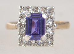 A hallmarked 9ct gold and amethyst ring, the central amethyst surrounded by clear cz stones.