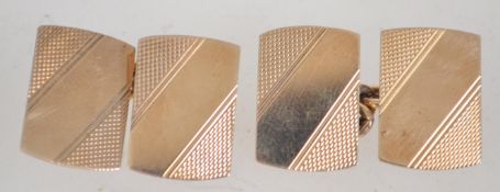 A pair of 9ct gold gentlemans cufflinks being engine turned with banded and stripe concentric