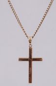 A 9ct gold pendant necklace strung with a crucifix. Measures - chain 20 inches, pendant 4cms.