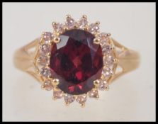 A 14ct yellow gold substantial garnet and diamond ring. The central garnet approx 3.5cts.