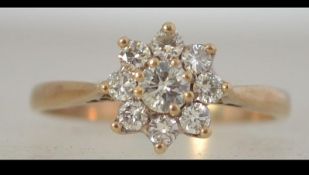 A 9ct gold diamond cluster daisy ring, the diamonds approx 40- points. Size L. Tests 9ct gold.