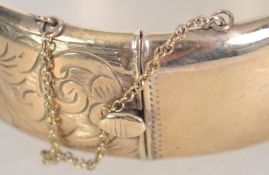 A large 9ct gold / 375 hallmarked ladies bangle complete with the safety clasp.