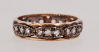 A white and yellow metal band ring set with clear stones. Weight 3.4g. Size P.