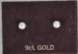 A pair of tested 9ct gold stud earrings set with cultured pearls, with post backs marked 375.
