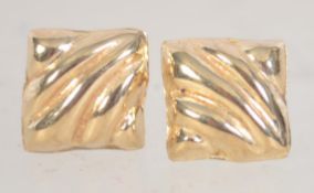 A pair of 9ct gold stud earrings with scalloped decoration with post backs. Test 9ct gold.