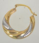 A pair of 9ct gold hoop earrings with textured white gold decoration. Marked 375. Tests 9ct gold.
